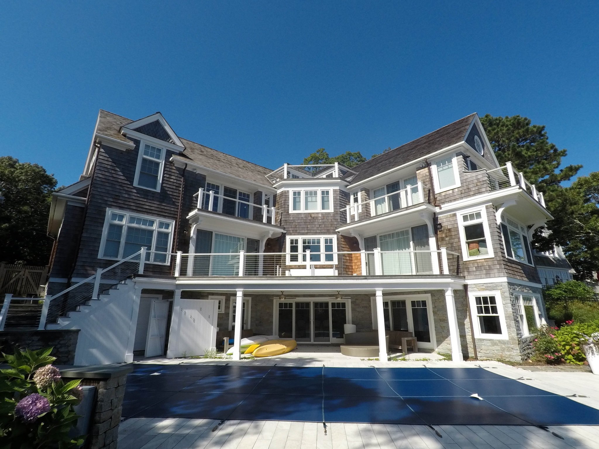 Large three level custom Cape Cod home with outdoor pool patio